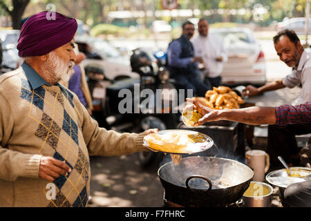 Man enjoying meal of Chole Bhature, Sector 7, Chandigarh, Punjab / Haryana Province, India Stock Photo