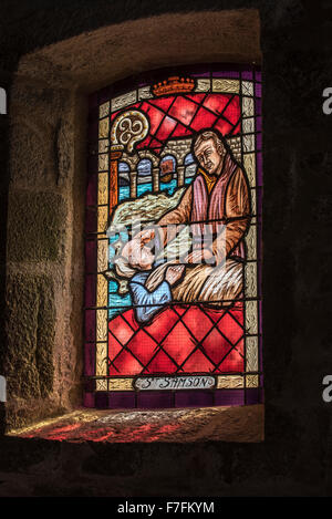 Stained-glass window showing St Samson curing man from leprosy in Saint-Samson chapel, Landunvez, Finistère, Brittany, France