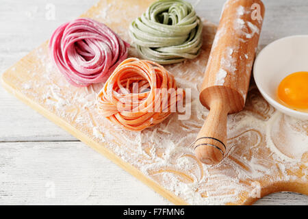 raw italian color pasta on board, food close-up Stock Photo