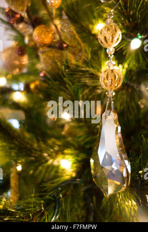 Beautiful Christmas ornaments are hung on an elegant Christmas tree with white lights. Stock Photo