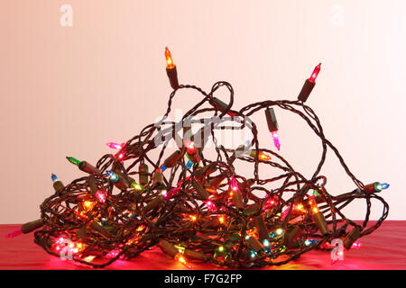 A tangle of indoor Christmas fairy lights in a domestic setting - England Stock Photo