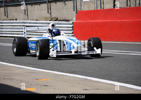 Blue and white racing car coming into pit at Brands Hatch Stock Photo