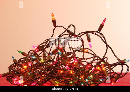 A tangle of indoor Christmas fairy lights in a domestic setting - England Stock Photo