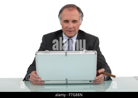 Businessman looking in a briefcase Stock Photo