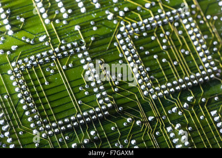 rows of soldered electrical components on circuit board showing solder connections computing motherboard Stock Photo