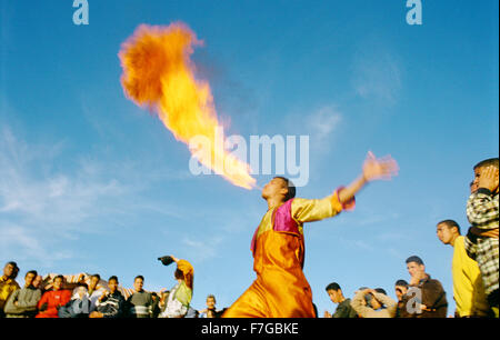 A fire breather spits fire at Jema al-Fna as a crowd looks on. Marrakech, Morocco, North Africa Stock Photo