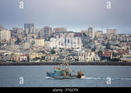 A San Francisco fishing boat cruises in front of the Marina neighborhood on San Francisco Bay Stock Photo