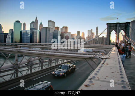 NEW YORK - JUN 25: Local people, tourists and cars on Brooklyn bridge, June 25, 2008 in New York Stock Photo
