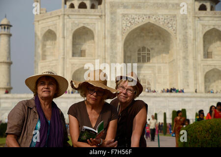 Foreign visitors pose to a photo in front of Taj Mahal in Agra,India Stock Photo