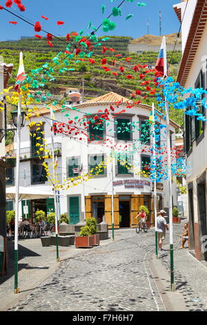 Street decorated with paper flowers on feast of Madeira, Camara de Lobos, Madeira Island, Portugal Stock Photo