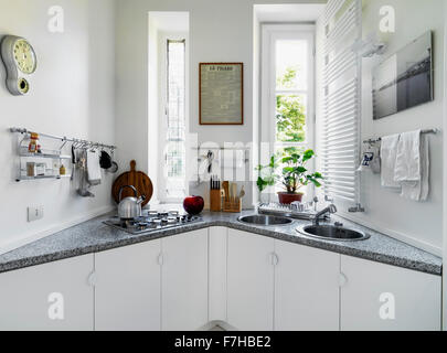 appliances on the marble worktop, two round sinks and cooker in the modern kitchen Stock Photo