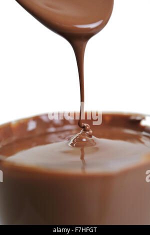 macro shoot with hot chocolate falling from spooin isolated on white in studio Stock Photo