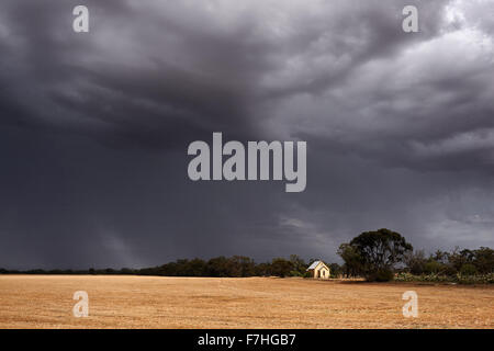 Summer storm moves over harvested cereal crop. Stock Photo