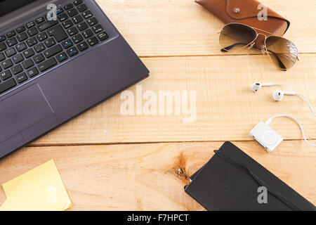 Collection of objects of an freelance worker or someone who works at home, on wooden background illuminated with natural light a Stock Photo
