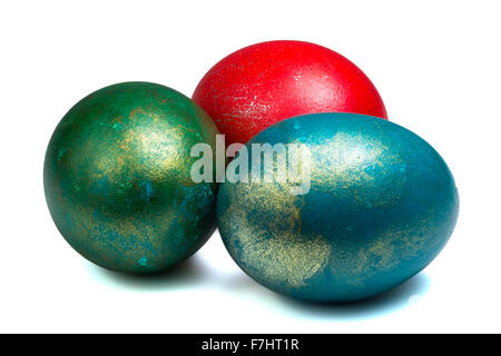 three painted easter eggs with metallic glitter isolated Stock Photo