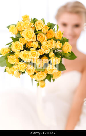 Closeup portrait of a bride holding flowers. Focus on flowers Stock Photo