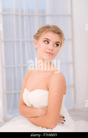 Portrait of a bride in white wedding dress looking away Stock Photo