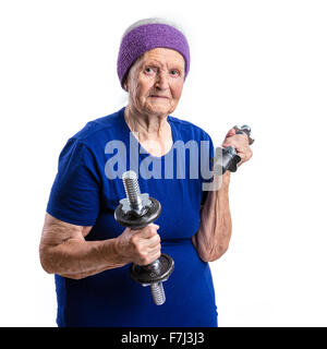 Senior woman working out with dumbbells over white background Stock Photo