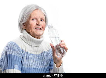 Senior woman with a bottle of water over white background Stock Photo