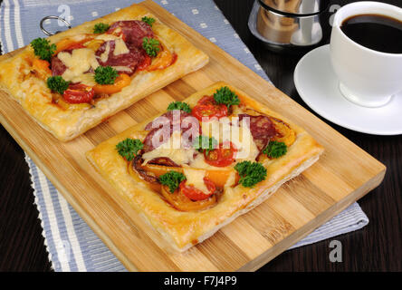 Mini pizza with vegetables, salami and cheese Stock Photo