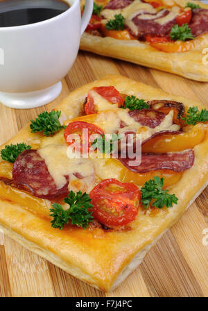 Mini pizza with vegetables, salami and cheese Stock Photo