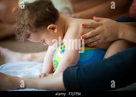 INFANT BEING MASSAGED Stock Photo