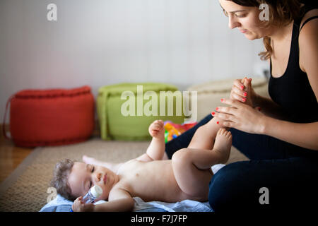 INFANT BEING MASSAGED Stock Photo