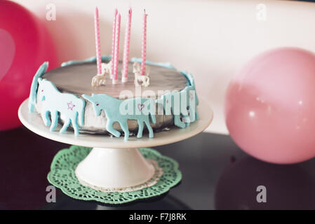 Birthday cake decorated with unicorns Stock Photo