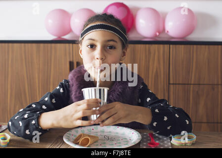 Girl drinking through a straw Stock Photo