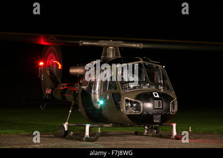 Vintage Westland Scout AH Mk1 Helicopter of the Historic Aircraft Flight Trust at night with rotors spinning for take off Stock Photo