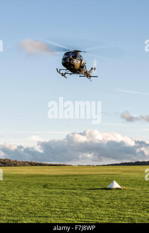 Vintage Westland Scout AH Mk1 Helicopter of the Historic Aircraft Flight Trust hovers over the School of Army Flying Stock Photo