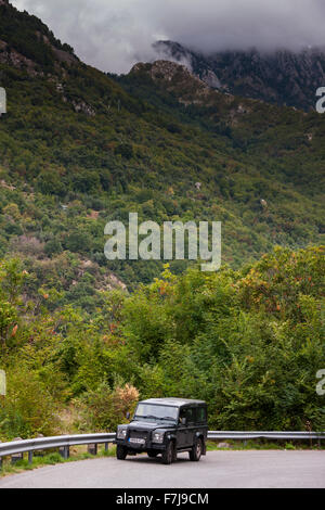 Landrover Defender on the Altagnana village road looking back into the Tuscan mountains. Stock Photo