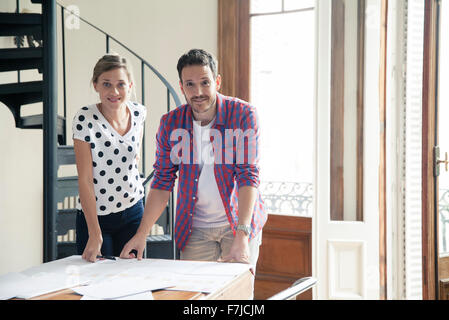 Design team reviewing blueprints Stock Photo
