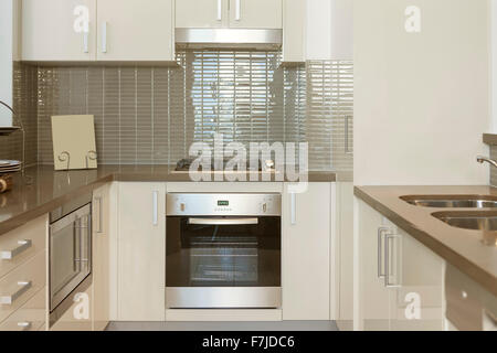 Small modern kitchen with built in stove and microwave Stock Photo