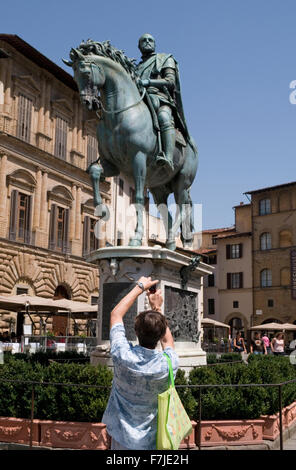 tourist taking a picture of Statue of Cosimo I de Medici, Piazza della Signoria, Florence Stock Photo