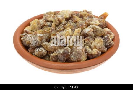 A serving of pitted chopped dates in a small bowl isolated on a white background. Stock Photo