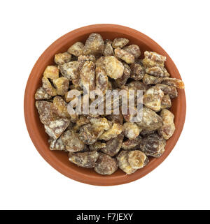 Top view of a serving of pitted chopped dates in a small bowl isolated on a white background. Stock Photo