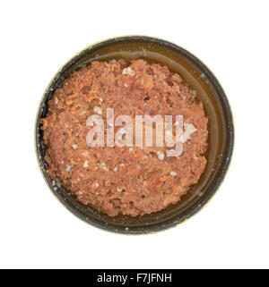 Top view of a large chunk of canned corned beef in the tin can with brine isolated on a white background. Stock Photo