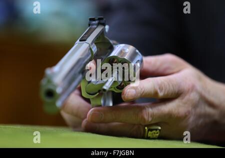 A man holds a 357 Magnum revolver by firearms manufacturer Smith & Wesson in an arms shop in Kaufbeuren, Germany, 01 December 2015. Photo: KARL-JSEOF Hildenbrand/dpa Stock Photo