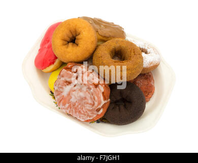 An old platter with several donuts and an iced cherry fritter isolated on a white background. Stock Photo