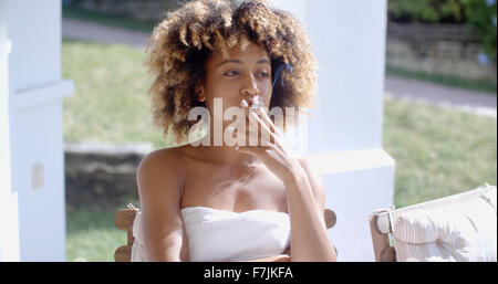 Woman Sittin on Terrace And Smoking Stock Photo