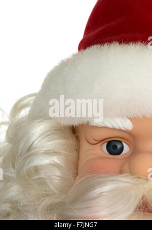 A partial view of an old Santa Claus plastic doll face decoration with hat and beard. Stock Photo
