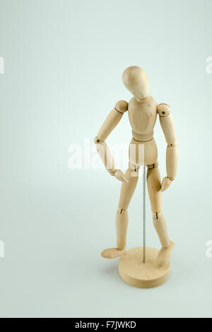 A wooden mannequin doll in standing pose, isolated on white background Stock Photo