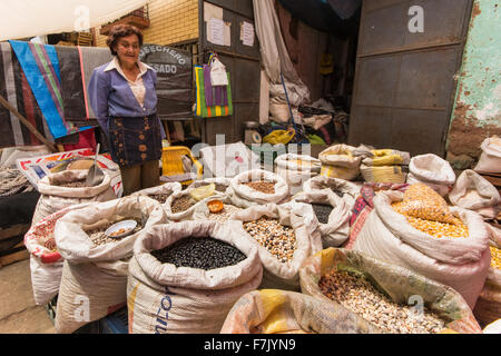 Woman sells various types of beans and corn at street market in town of Cajabamba in Cajamarca region of Peru Stock Photo