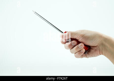 A hand holding red screwdriver, isolated in white background Stock Photo