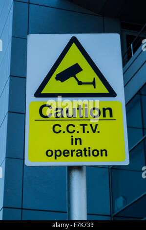 A yellow caution cctv in operation sign Stock Photo