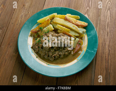 Stoofvlees - Dutch Stoverij, traditional Belgian and French Flemish sweet-sour beef and onion stew . Stock Photo