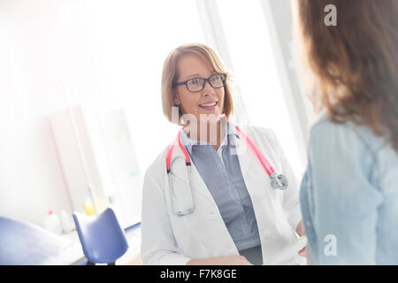 Doctor and patient talking in examination room Stock Photo