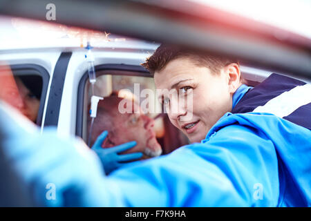 Close up rescue worker tending to car accident victim Stock Photo