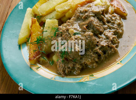 Stoofvlees - Dutch Stoverij, traditional Belgian and French Flemish sweet-sour beef and onion stew . Stock Photo